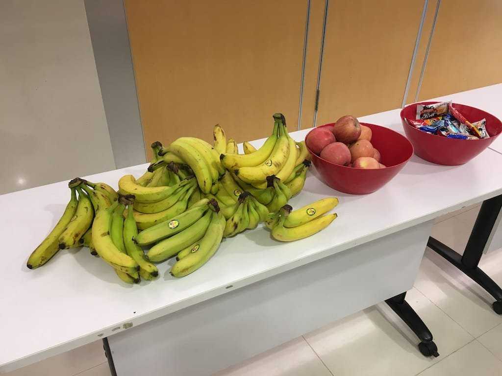 Banana, apple and snacks on a table at Webconf.Asia